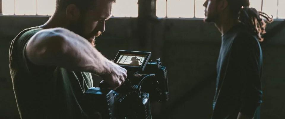 A camera operator framing an actor on a location shoot